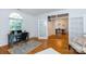 Home office with hardwood floors, natural light from a large window, and French doors to the dining room at 6507 Fairway Point Dr, Charlotte, NC 28269