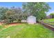 The spacious backyard features a shed, mature trees, and a wooden fence at 6922 Brandon Chase Ln, Concord, NC 28025