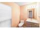 This bathroom features a gray vanity, white toilet, and blinds at 6922 Brandon Chase Ln, Concord, NC 28025