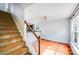 Inviting living room features hardwood flooring, neutral paint, and access to a staircase at 6922 Brandon Chase Ln, Concord, NC 28025