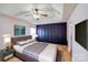 This primary bedroom features a tray ceiling, a ceiling fan, and a panel accent wall at 6922 Brandon Chase Ln, Concord, NC 28025