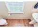 Bathroom showcasing wood floors, toilet and sink under a window with blinds at 6961 Liverpool Ct, Fort Mill, SC 29707