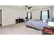 Large bedroom boasts a ceiling fan, soft carpet, and ample natural light at 6961 Liverpool Ct, Fort Mill, SC 29707