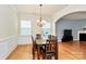 Spacious dining room with hardwood floors, a chandelier, and adjacent living space at 6961 Liverpool Ct, Fort Mill, SC 29707
