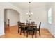 Elegant dining room with hardwood floors, chandelier, and a dining table set for six at 6961 Liverpool Ct, Fort Mill, SC 29707