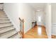 Inviting foyer with hardwood floors, staircase, and a decorative table, creating a warm entrance at 6961 Liverpool Ct, Fort Mill, SC 29707
