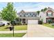 Two-story home featuring brick and gray siding, a two-car garage, well-maintained lawn and landscaped front yard at 6961 Liverpool Ct, Fort Mill, SC 29707