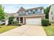 Two-story home with brick and gray siding, a two-car garage, well-maintained lawn and manicured front yard at 6961 Liverpool Ct, Fort Mill, SC 29707