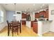 Open-concept kitchen flowing into dining area with stainless appliances at 6961 Liverpool Ct, Fort Mill, SC 29707