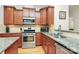 Stylish kitchen with stainless appliances, granite counters, and dark wood cabinets at 6961 Liverpool Ct, Fort Mill, SC 29707