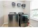 Laundry room featuring a washer and dryer with overhead wire shelving at 6961 Liverpool Ct, Fort Mill, SC 29707