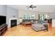 Spacious living room features a fireplace, hardwood floors, and large sectional sofa at 6961 Liverpool Ct, Fort Mill, SC 29707