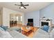 Cozy living room with gray sectional, fireplace, and hardwood floors at 6961 Liverpool Ct, Fort Mill, SC 29707
