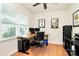 Well-lit office space with hardwood floors, a large window, and functional workspace at 6961 Liverpool Ct, Fort Mill, SC 29707