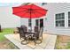 Outdoor patio featuring an umbrella covered table and chairs with exterior house view at 6961 Liverpool Ct, Fort Mill, SC 29707