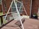 Backyard swing seat overlooking a deck with a brick house nearby at 7318 Brighton Brook Dr, Charlotte, NC 28212