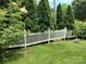 Well-manicured lawn framed by a charming white picket fence and lush greenery at 7318 Brighton Brook Dr, Charlotte, NC 28212