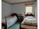 Bedroom featuring twin beds and classic wood furniture at 7318 Brighton Brook Dr, Charlotte, NC 28212
