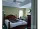 Cozy bedroom with a ceiling fan, large bed, and a window at 7318 Brighton Brook Dr, Charlotte, NC 28212