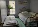 Bedroom featuring twin beds, a palm tree, and a window at 7318 Brighton Brook Dr, Charlotte, NC 28212
