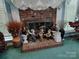 Close-up of a brick fireplace decorated with charming figurines and seasonal decor at 7318 Brighton Brook Dr, Charlotte, NC 28212