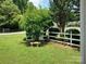 Front yard featuring a bench, a white picket fence, and manicured lawn at 7318 Brighton Brook Dr, Charlotte, NC 28212