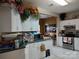 Well-lit kitchen featuring white cabinets, stainless steel appliances, and a view into the dining area at 7318 Brighton Brook Dr, Charlotte, NC 28212