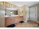 Bathroom featuring double sink vanity, tile floor, and plenty of light at 8137 Caliterra Dr, Charlotte, NC 28227