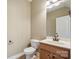 Bathroom features a wooden vanity with a stylish mirror and fixtures at 8137 Caliterra Dr, Charlotte, NC 28227