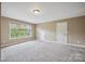 Neutral bedroom with window, carpet, neutral walls and door at 8137 Caliterra Dr, Charlotte, NC 28227