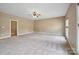 Large bedroom with neutral colors and carpet; includes ceiling fan and bathroom access at 8137 Caliterra Dr, Charlotte, NC 28227
