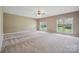 Bright bedroom featuring natural light from two large windows overlooking the well-manicured backyard at 8137 Caliterra Dr, Charlotte, NC 28227