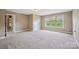Neutral bedroom with carpet, neutral walls and a big window at 8137 Caliterra Dr, Charlotte, NC 28227