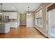 Cozy dining area with hardwood floors, large windows, and access to the kitchen at 8137 Caliterra Dr, Charlotte, NC 28227