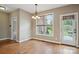 Bright dining area features hardwood floors, natural light and a stylish chandelier at 8137 Caliterra Dr, Charlotte, NC 28227