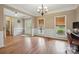 Formal dining room features hardwood floors, elegant wainscoting, and a chandelier, perfect for gatherings and entertaining at 8137 Caliterra Dr, Charlotte, NC 28227