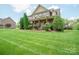 Lovely two-story home has a lush green lawn with manicured shrubbery and large shade trees in a desirable neighborhood at 8137 Caliterra Dr, Charlotte, NC 28227