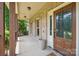 Inviting covered front porch has brick accents and decorative columns, creating a welcoming entrance to this lovely home at 8137 Caliterra Dr, Charlotte, NC 28227
