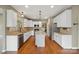 Stylish kitchen with white cabinets, granite countertops, and stainless steel appliances at 8137 Caliterra Dr, Charlotte, NC 28227