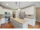 Elegant kitchen with a large island, stainless steel appliances, and hardwood floors at 8137 Caliterra Dr, Charlotte, NC 28227