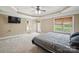 Main bedroom featuring a tray ceiling, ceiling fan, carpet and a door to the outside at 8137 Caliterra Dr, Charlotte, NC 28227