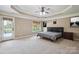 Main bedroom featuring a tray ceiling, ceiling fan, carpet and a door to the outside at 8137 Caliterra Dr, Charlotte, NC 28227