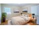 Stylishly staged bedroom with artwork and side tables illuminated by lamps at 823 Yuma St, Charlotte, NC 28213