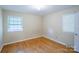 Bedroom featuring hardwood floors and two windows that provides plenty of natural light at 823 Yuma St, Charlotte, NC 28213