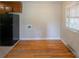 Dining area with hardwood floors, neutral walls, and natural light from a window near the kitchen at 823 Yuma St, Charlotte, NC 28213