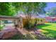 Brick house with a carport and green lawn, offering practical covered parking and outdoor space at 823 Yuma St, Charlotte, NC 28213