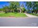Charming single-story home with lush green lawn and mature trees shading the front yard at 823 Yuma St, Charlotte, NC 28213