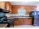 Functional kitchen featuring a range, double sink and abundant storage space within dark cabinetry at 823 Yuma St, Charlotte, NC 28213