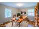 Sun-filled home office with desk, chair, bookshelf, and ample natural light at 823 Yuma St, Charlotte, NC 28213