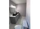 Stylish bathroom with double vanity, black vessel sinks, gray cabinets, and marble-look tile flooring at 830 Mcarthur Ave, Charlotte, NC 28206
